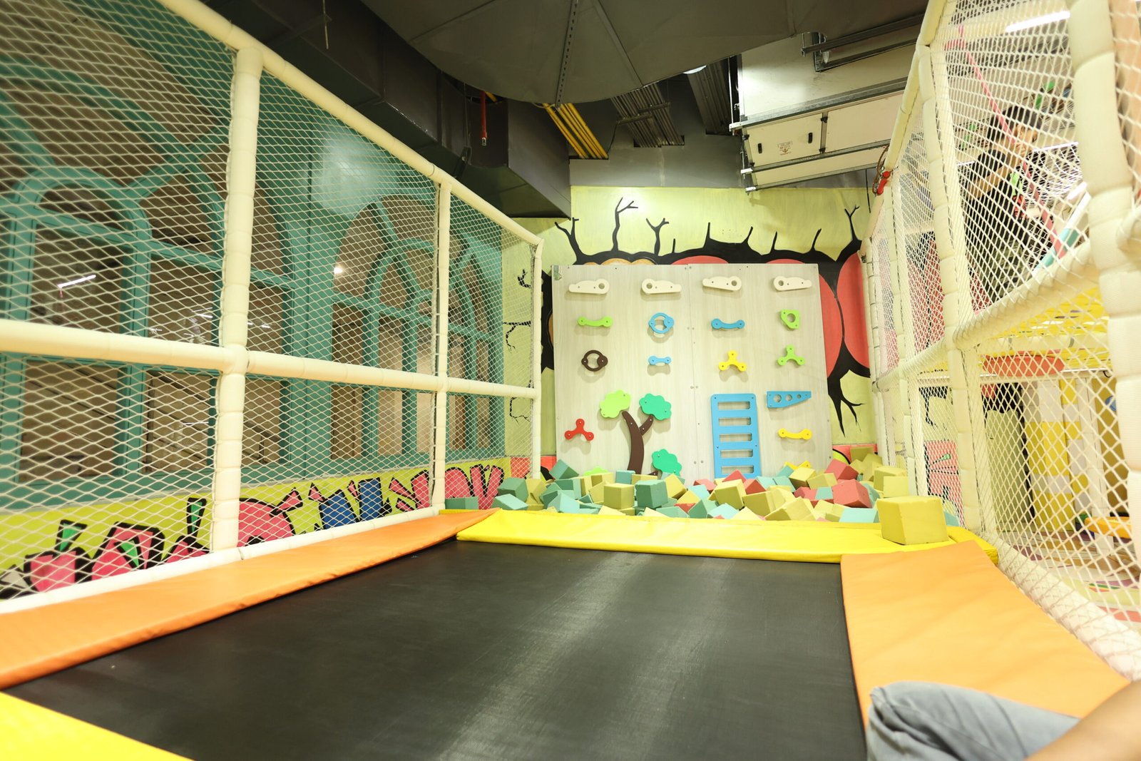 a indoor playground with a white fence and a white net
