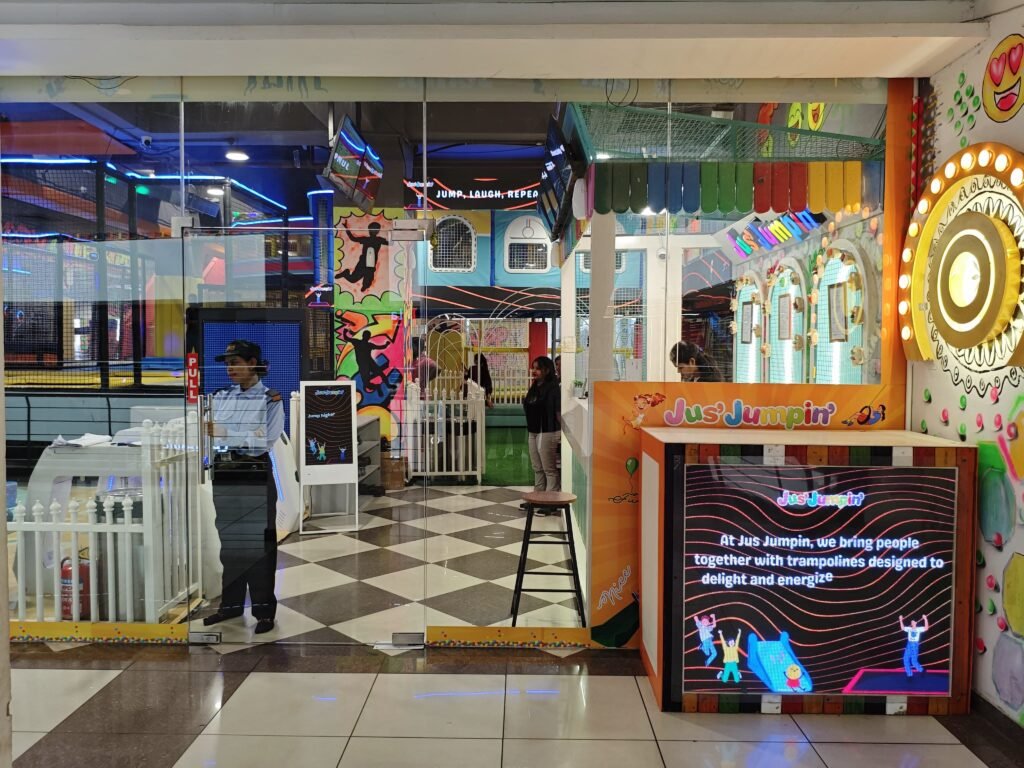 Indoor trampoline park entrance with signage.