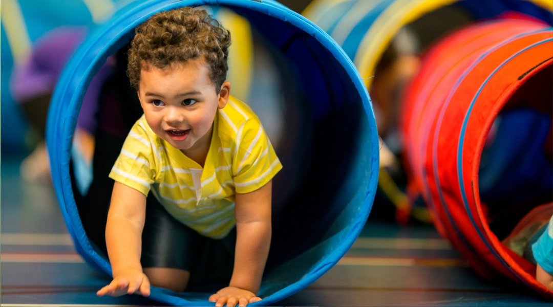 Children playing in colorful indoor soft play zone